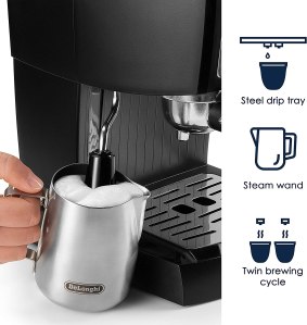 A silver DeLonghi EC155M Espresso Machine on a countertop, with a cup of espresso and milk frother in the background.